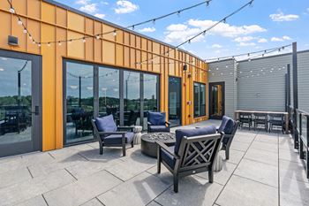 A patio with a table and chairs is set up on a rooftop.